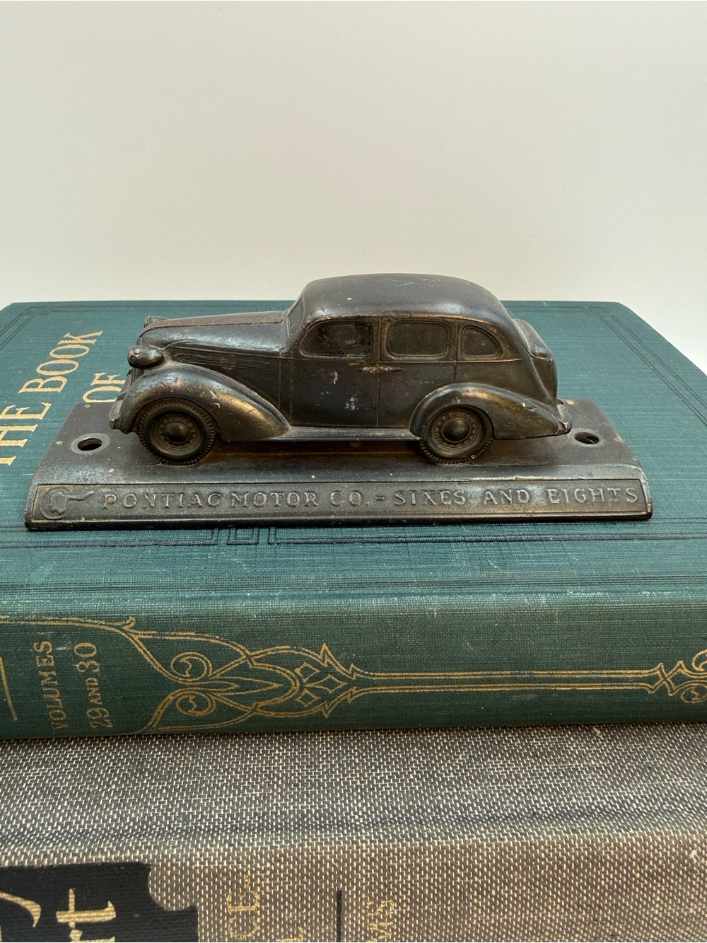 Vintage Pontiac Motors “sixes and eights” antique paper weight